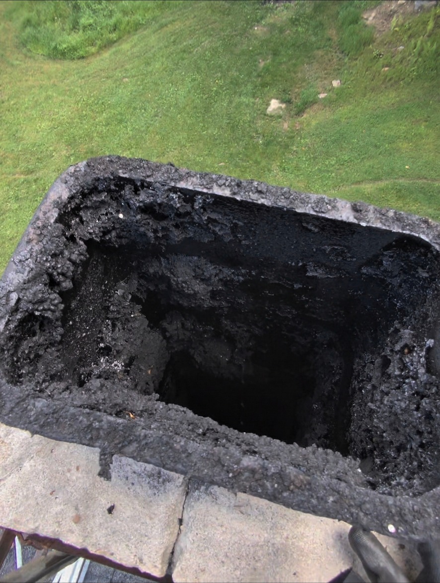 Chimney flue with heavy soot buildup before cleaning