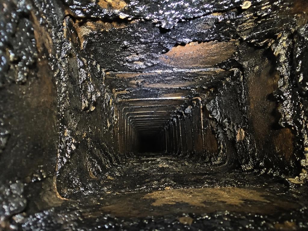 Soot buildup inside a chimney flue before sweeping